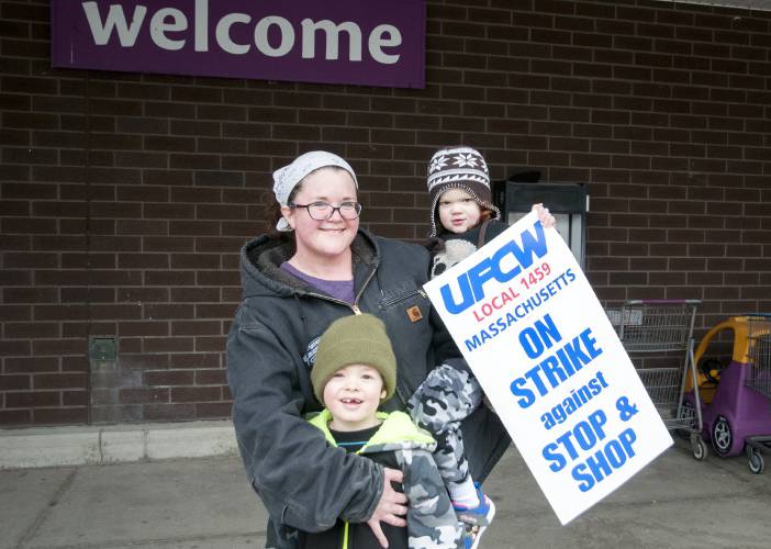 Stephanie Podlesny and her children Leo, 5, and Alarick, 3, show their solidarity with Greenfield's Stop &amp; Shop unionized workers who went on strike Thursday for a fair contract. Her husband, Frank has worked at the supermarket for 23 years. His current health insurance benefits cover the whole family, which may be on the chopping block for a new contract.
